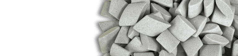 Close-up of ceramic ellipse-shaped media used for vibratory finishing