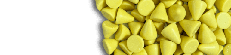 Yellow PH1 cone-shaped plastic media used for vibratory finishing