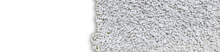 Close-up of TCX porcelain cylinder-shaped media used for polishing in vibratory finishing