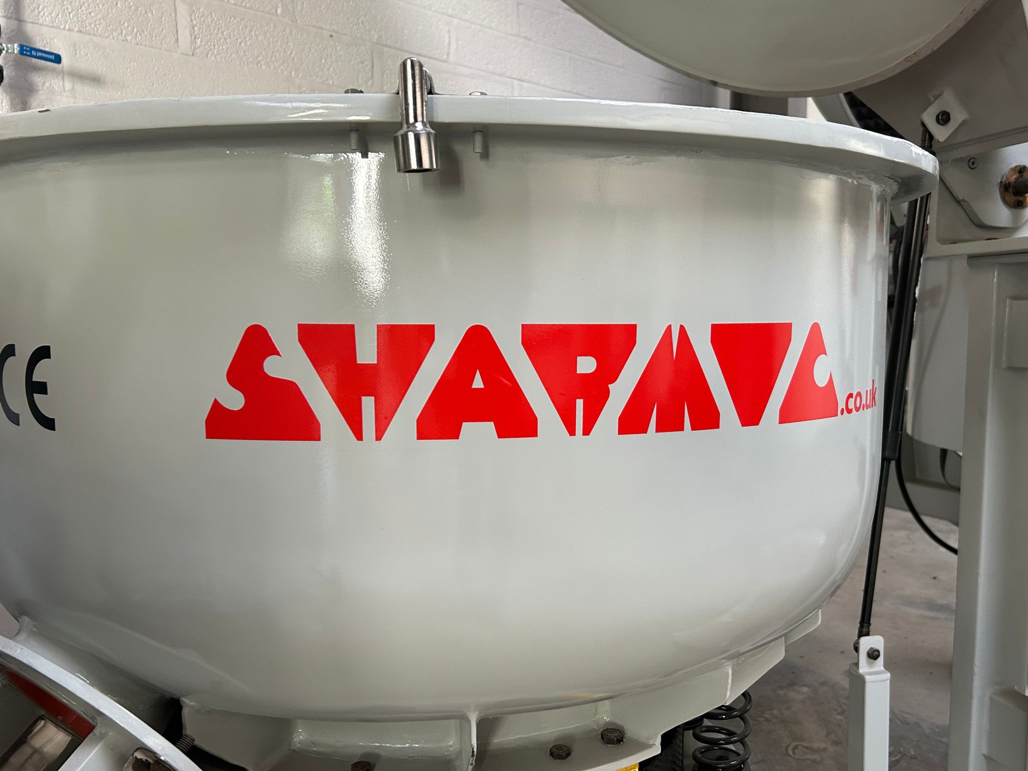 Close-up view of an SM range finishing machine with the Sharmic logo clearly visible.