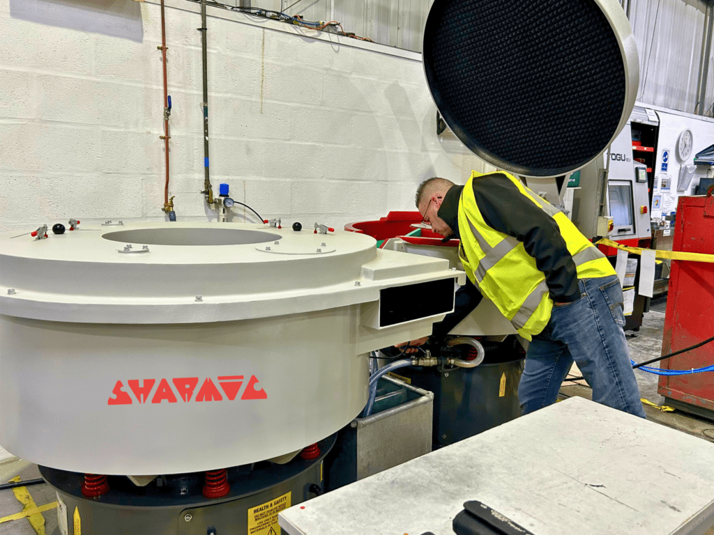 VRX 350 vibratory machine and drier being commissioned at customer site, with technician Garry checking drain outlets.