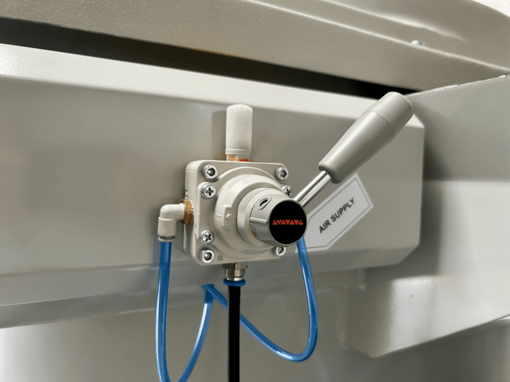 Close-up of VRK pneumatic handle for automatic unload with Sharmic logo visible.