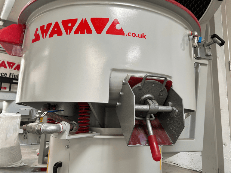 VRX 300L vibratory finishing machine showing quick release media chute, springs, and outlet valve.