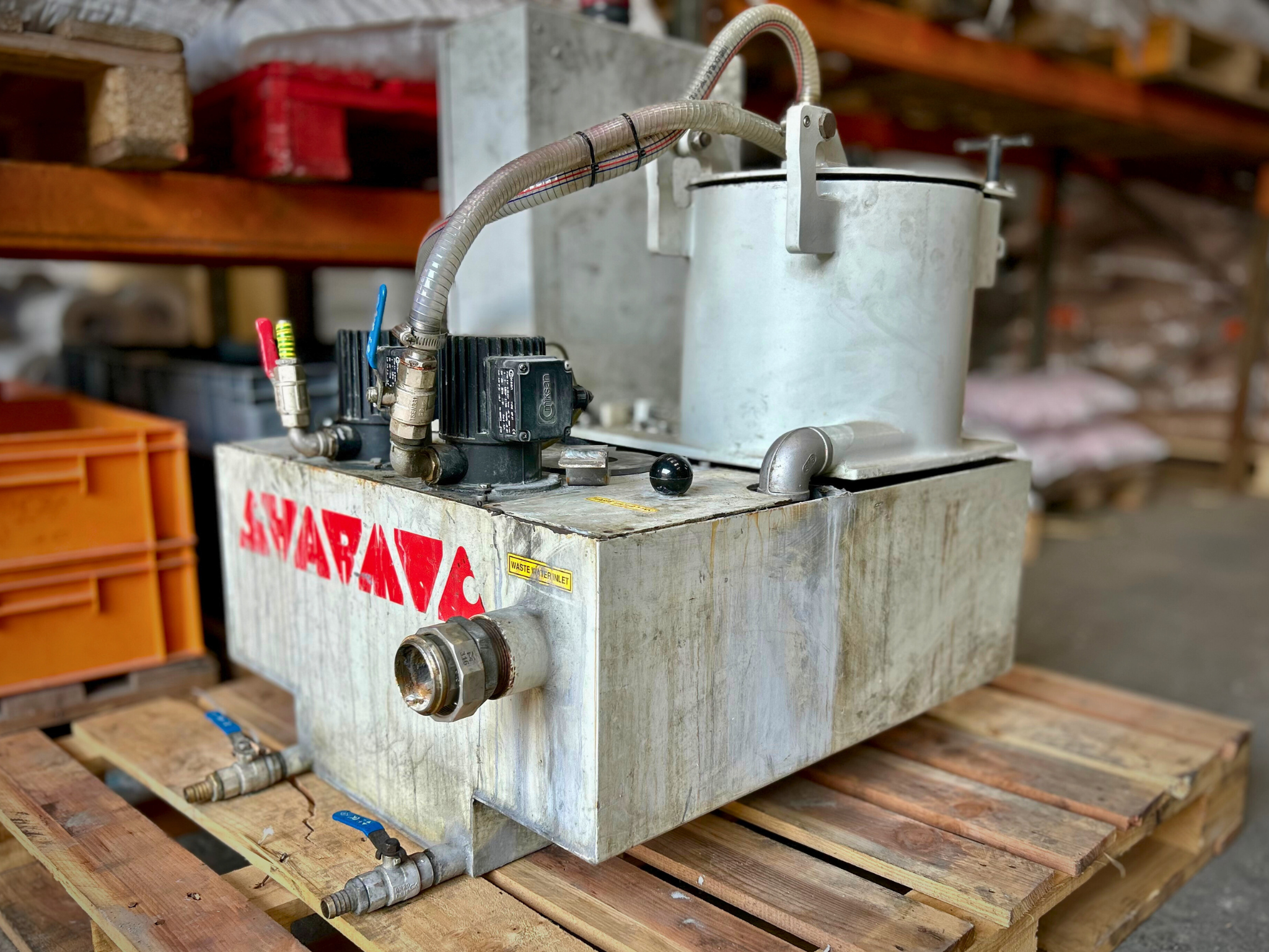 Well-used centrifugal water treatment system on a pallet awaiting repair service.