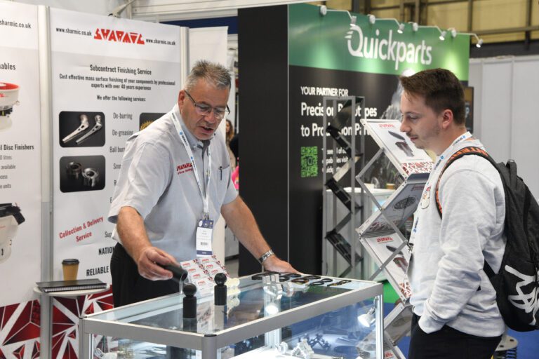 Garry at an exhibition demonstrating the before and after surface finish on a plastic component.