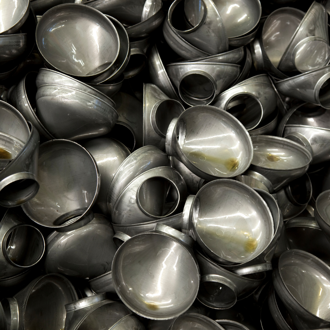 Metal components coated with grease prior to cleaning or finishing processes.