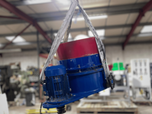 Centrifugal finishing machine lifted with equipment during repair and maintenance work